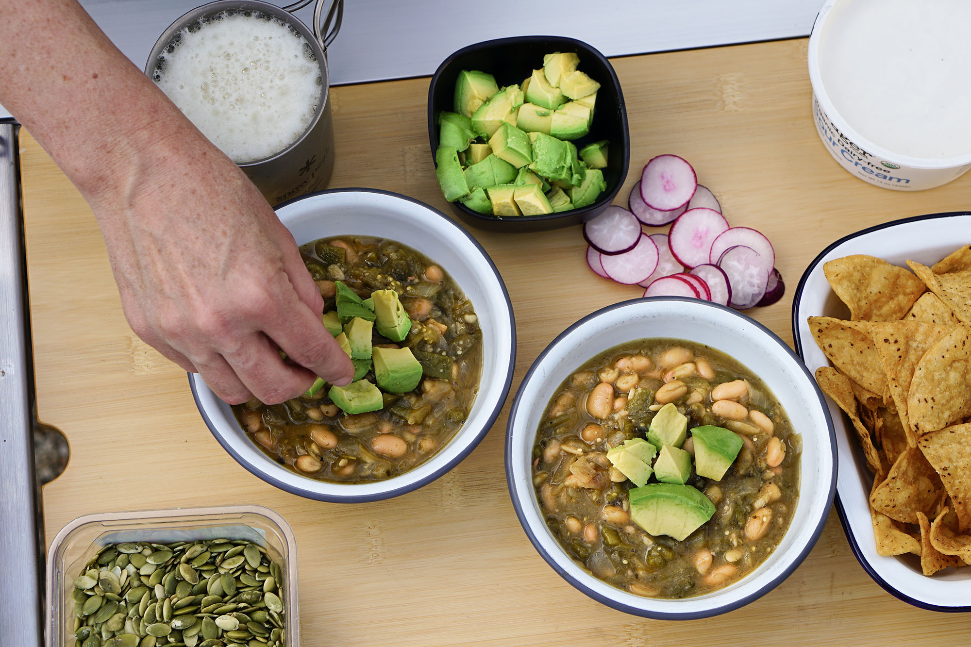 White Bean Chili Verde with radishes and avocado
