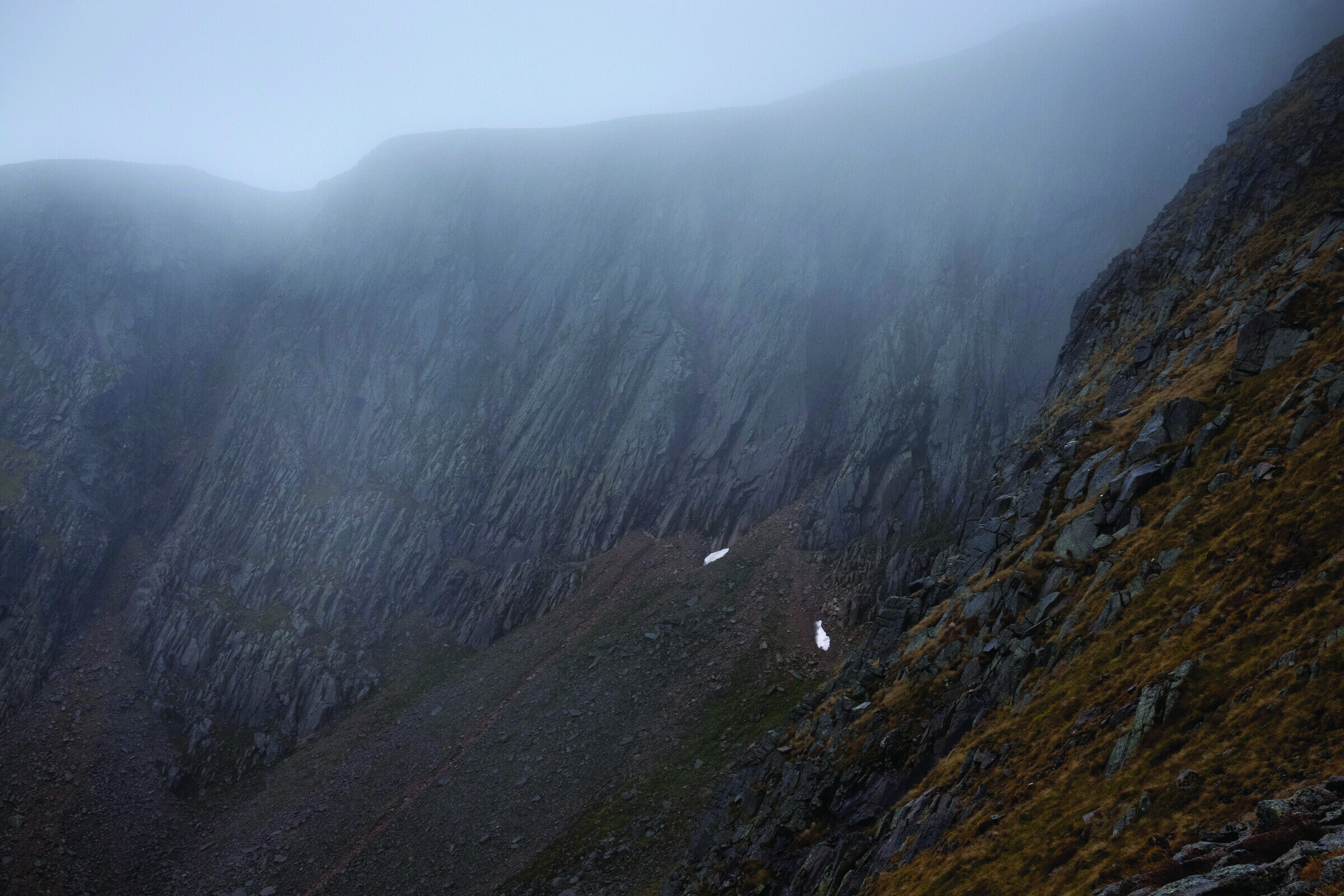 Foggy hillside in the Scottish Cairngorms with snow patches