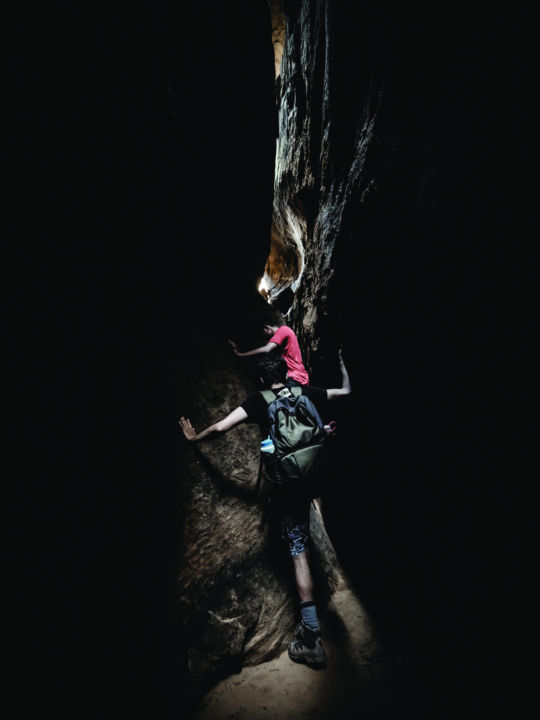 Rock climber in a dark cave