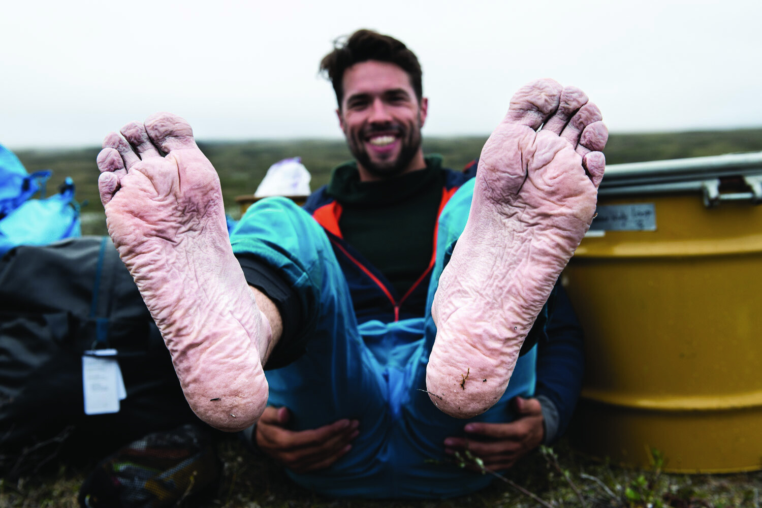 Water-wrinkled feet held up after a long day on the water